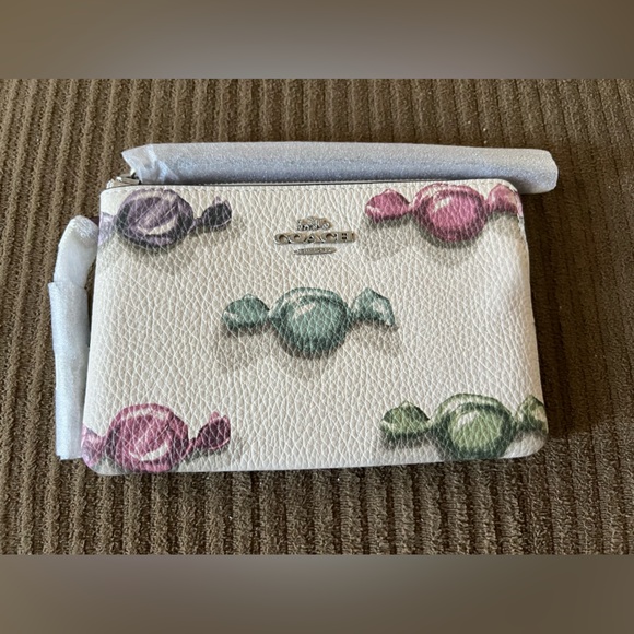 Coach Handbags - Coach Corner Zip Wristlet
With Candy Print And Charm NWT w/packaging